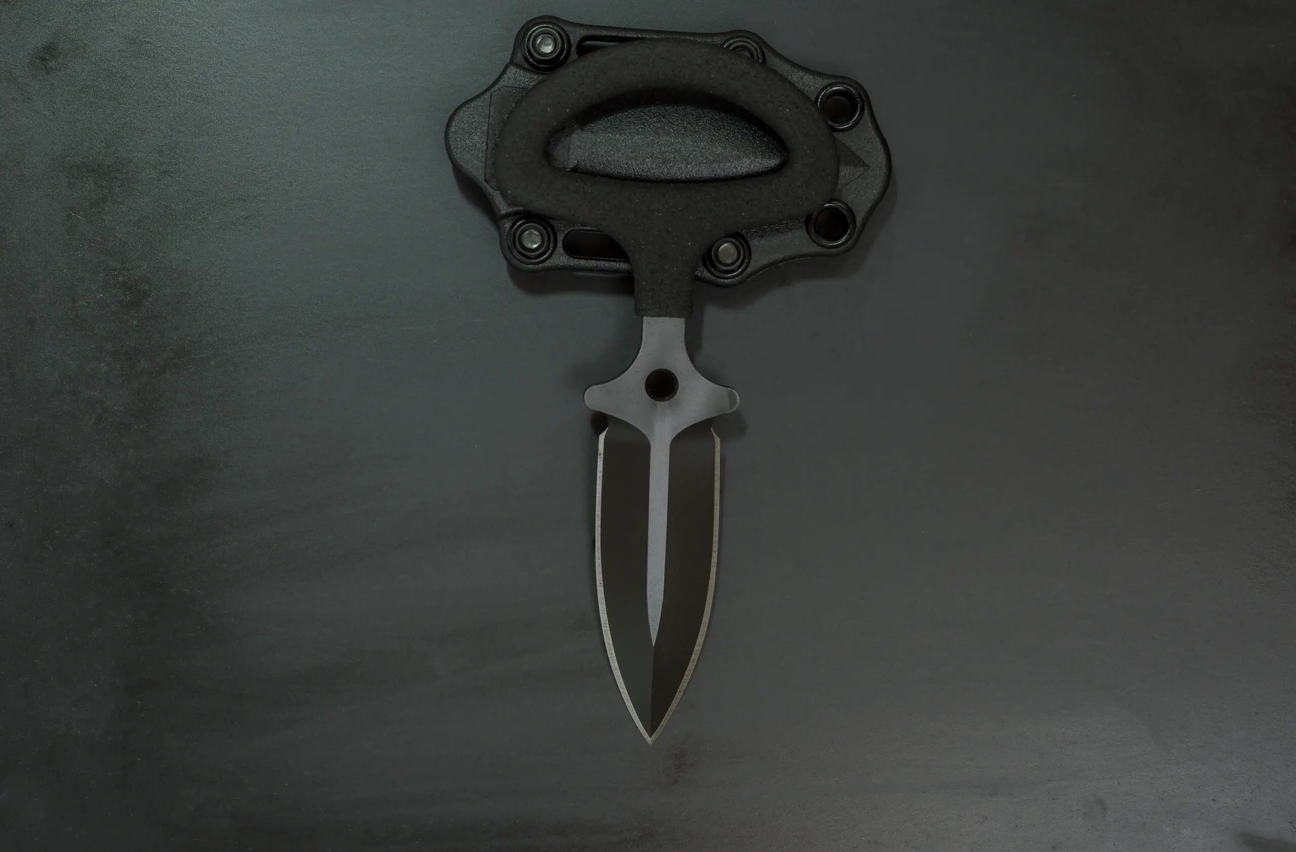 Knife push dagger. Black knife with double edge spear point blade. Black knife and black sheath.
